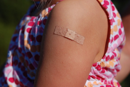 Sticking plaster on child after vaccination shotの写真素材