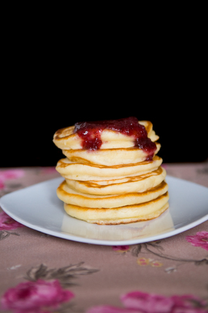 A pile of pancakes on a plate.