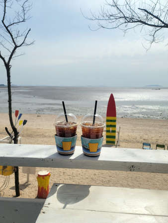 Cool coffee time on the beach in midsummerの写真素材