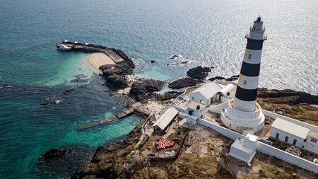 Mudouyu Lighthouse, the lighthouse guides the direction of the boat, Stone tidal in the sea is a traditional fishing method.の写真素材