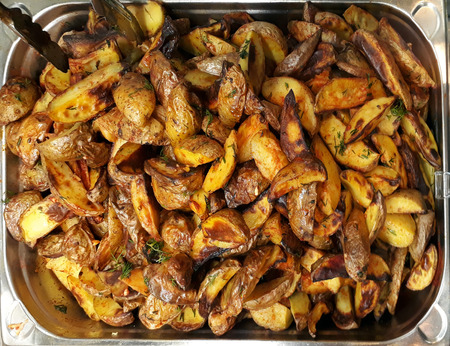 Cooked potatoes Idaho with dill on the trayの写真素材
