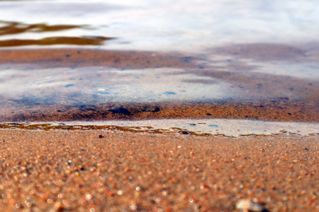 The sandy shore of the lake, a gentle breeze and a calm wave coming ashoreの写真素材