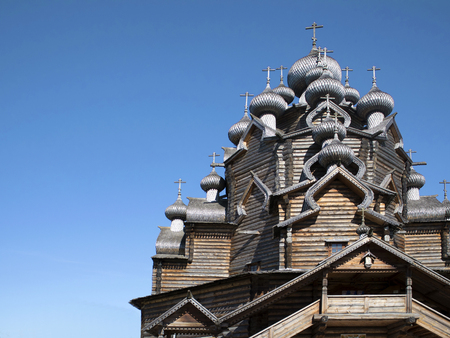Old wooden ortodox cathedral made without nails against blue skyの写真素材