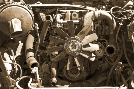 Old broken and dirty car car close up, view under the hood in sepia tonesの写真素材