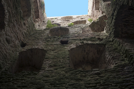 Inside view of ancient medieval fortress tower with open top, limestone walls with embrasuresのeditorial素材