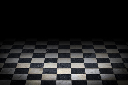 Antique checkered marble floor. Black and white tiled background with black top gradient and darkened vignetteの写真素材