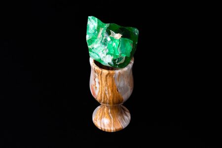 Small elegant stone glass of natural onyx with piece of green glass insideの写真素材