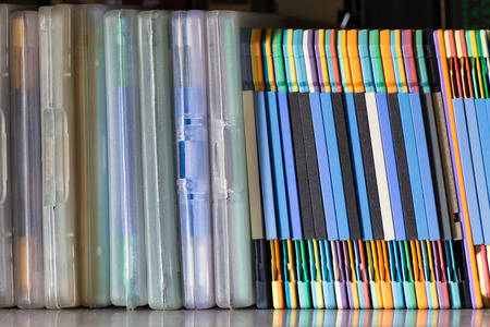 Group of floppy disk: side view of a floppy disk group on a shelf.