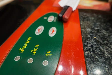Close up shot of Heat level buttons of pot in Thai language
