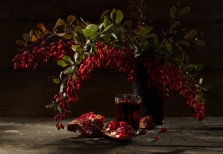 pomegranate and barberry berries on wooden backgroundの写真素材