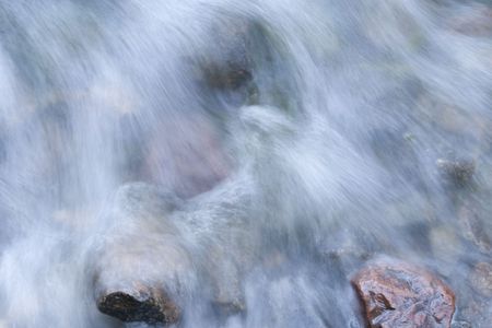 Sea waves washing over rocksの写真素材