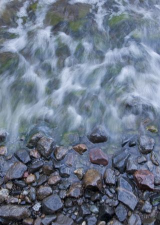 Sea waves washing over rocksの写真素材