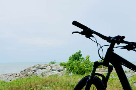 Black bicycle standing near the beachの写真素材