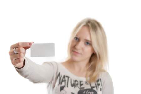 Girl with the business card in her hand isolated in whiteの写真素材