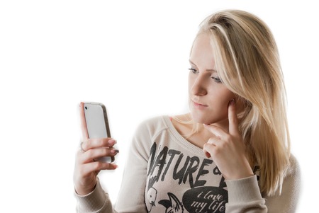 Young beautifull girl with popular phone isolated on whiteの写真素材