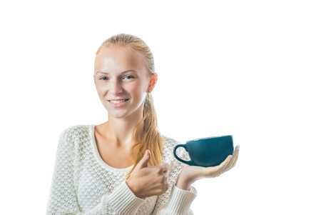 Portrait of beautiful young woman with cup of tea, isolated on whiteの写真素材