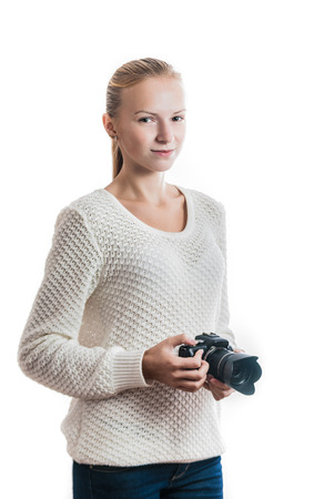Young girl with digital camera, taking a picture isolated on whiteの写真素材