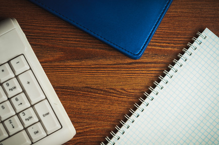 Composition with scratchpad, notepad and keyboard on the wooden deskの写真素材