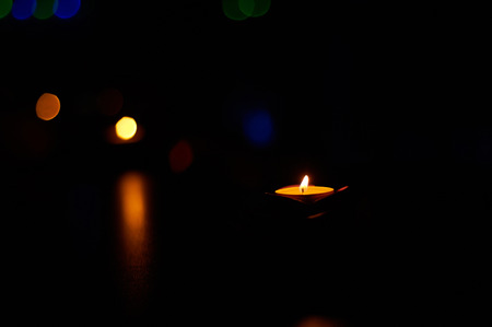Burning candles on the dark wooden table. Selective focusの写真素材