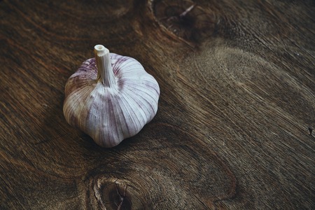 Photo of head of garlic on wooden tableの写真素材