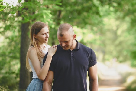 Portrait of young couple hugging on green backgroundの写真素材