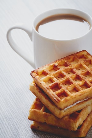 Wafers and the cup of cocoa on the wooden tableの写真素材