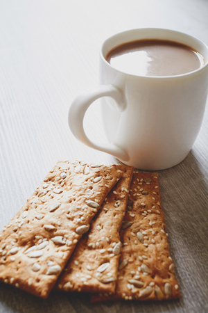 Biscuits and cup of cocoa on the wooden tableの写真素材