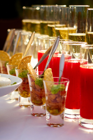 Some food and drinks in glasses on the tableの写真素材