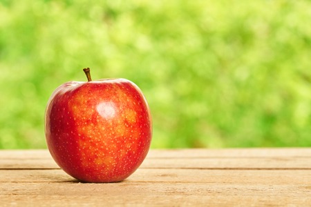 Red apple on the wooden tableの写真素材