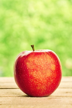 Red apple on the wooden tableの写真素材