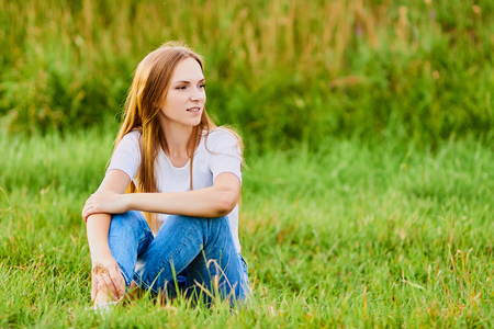Happy young girl in the fieldの写真素材