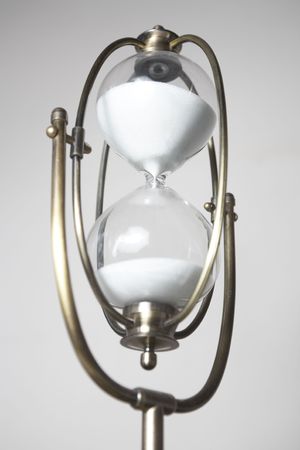 Antiquarian sand-glass on a white background