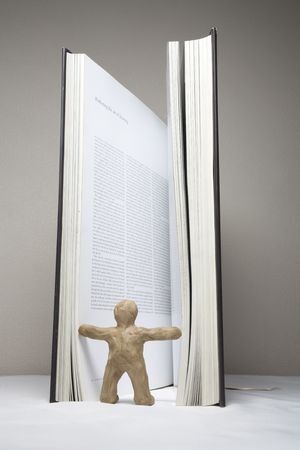 The plasticine person studies the book from the different partiesの写真素材