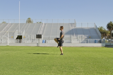 A Caucasian man in his twenties works out at a stadium.の写真素材