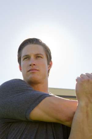 A Caucasian man in his twenties works out at a stadium.の写真素材