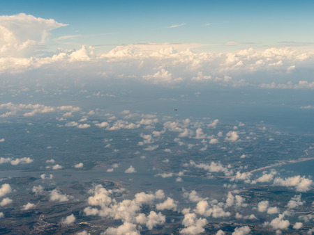 Aerial view of a countryside with cumulus cloudsの写真素材
