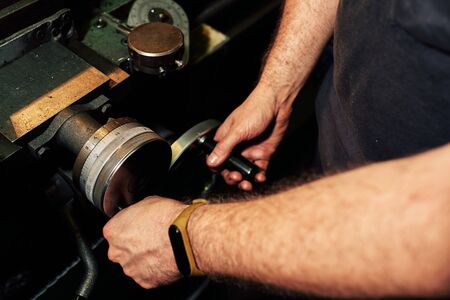 Mechanical Engineer Controlling Lathe Machine in Factory.の写真素材