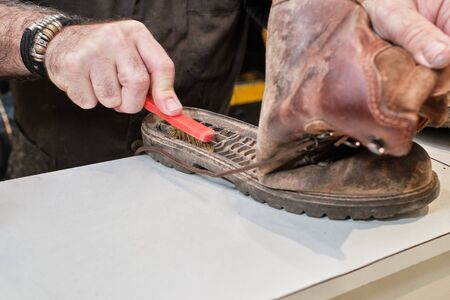 shoemaker man working in his shoe shopの写真素材