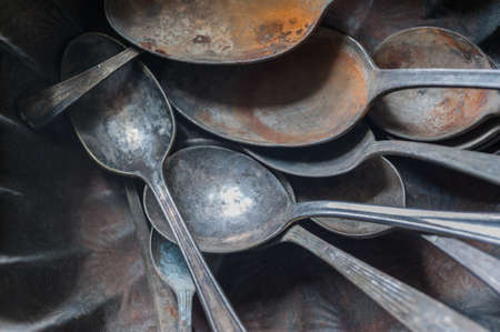Bowl of fusty spoons found at antique shopの写真素材