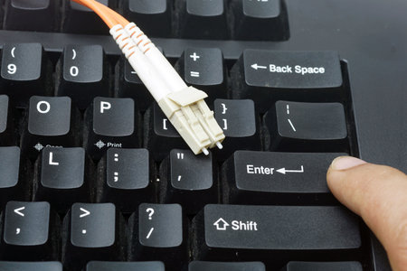 A computer keyboard with cable, concept of internet security and data protection.の写真素材