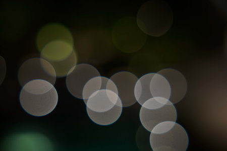 Abstract circular bokeh background, defocused lights on black backgroundの写真素材