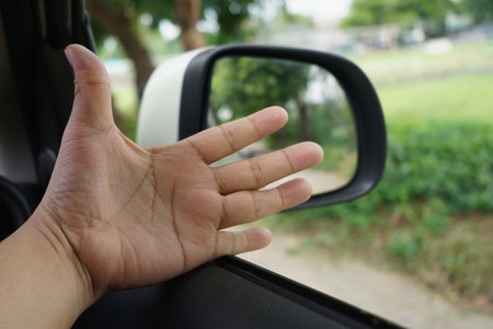 Abstract a hand on the side of the car with blur background, focus on hand.の写真素材