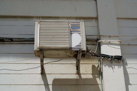 A old air conditioner on the wall of a building,の写真素材