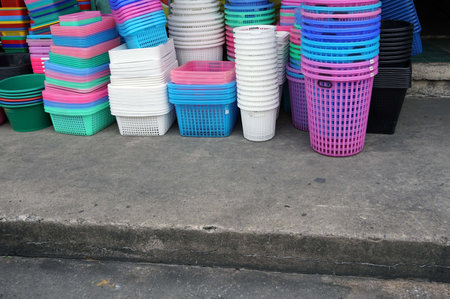A lot of a plastic baskets for sale on the street  in the market.の写真素材