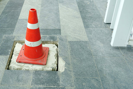 A cones on the pathwalk floor to protect was  fixxing a broken drain.の写真素材