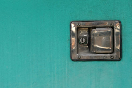 A old green door with a old vintage keyhole stainless steel and padlock, closeup of photoの写真素材