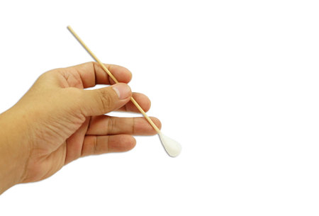 A cotton swab in a hand on white background, cleaning concept for health care.の写真素材