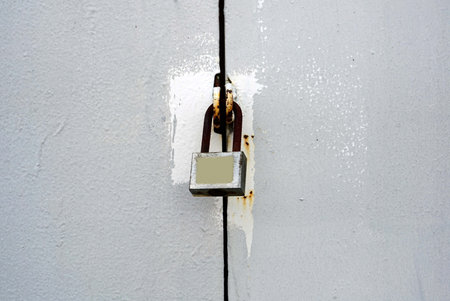 A old gray metal door lock with padlock, vintage door concept.