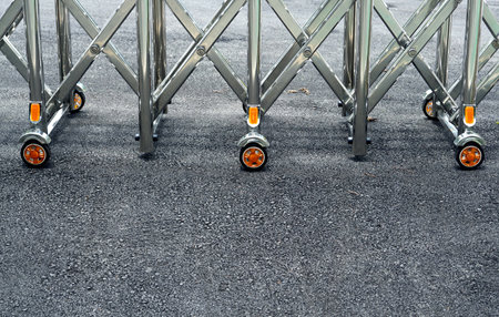 Close-up a metal wheel door entrance on asphalt floor.