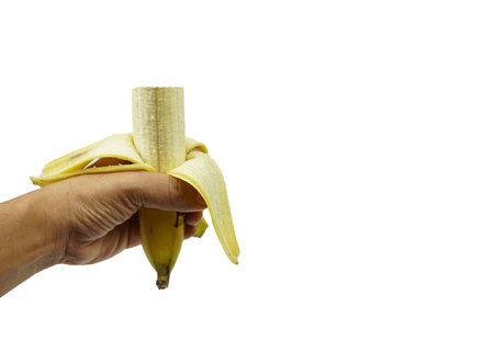 A banana was peeled and eaten in the hand isolated on white background, food and health concepts.の写真素材